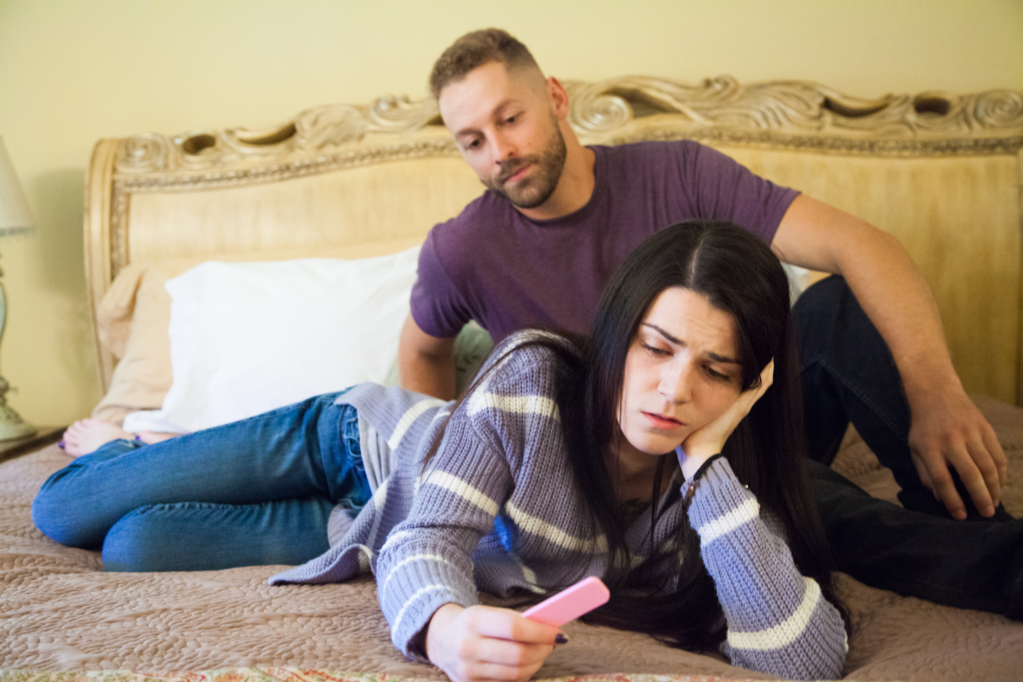 couple looking at a pregnancy test wondering what resources they can find to help