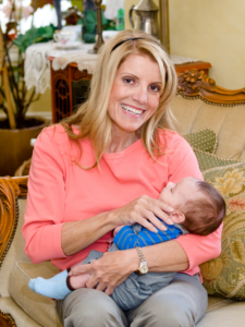 Mardie Caldwell, C.O.A.P. holding a baby in her arms as she tells an open adoption story